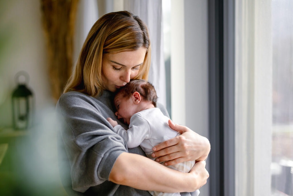 Mother holding newborn seeking postpartum depression treatment with ketamine therapy in Philadelphia